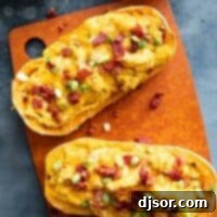 Savory Stuffed Butternut Squash Delight 7 Two butternut squash halves filled with butternut squash, cheese, and bacon.