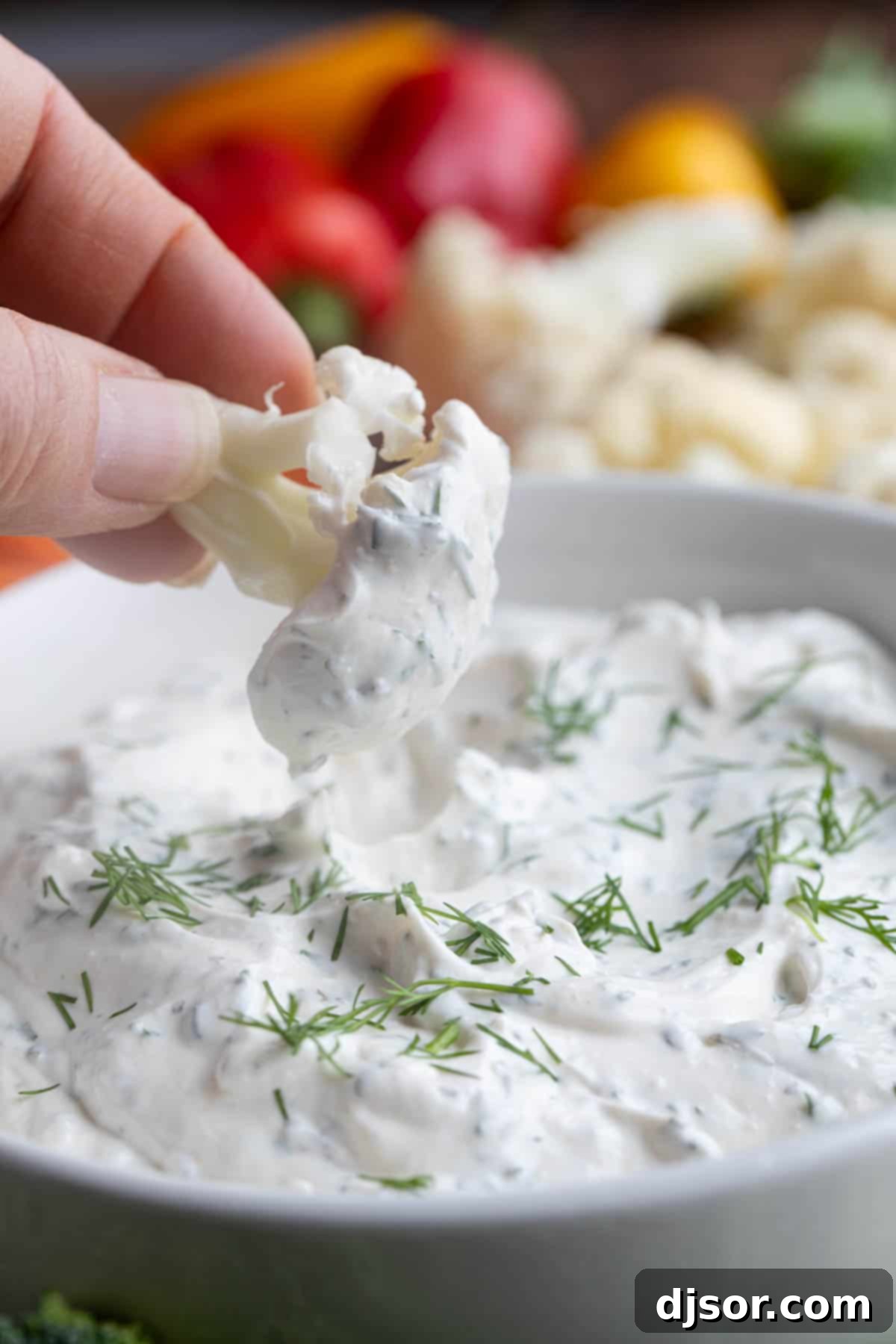 Creamy Dill Delight 7 Piece of cauliflower being dipped into Dill Dip.