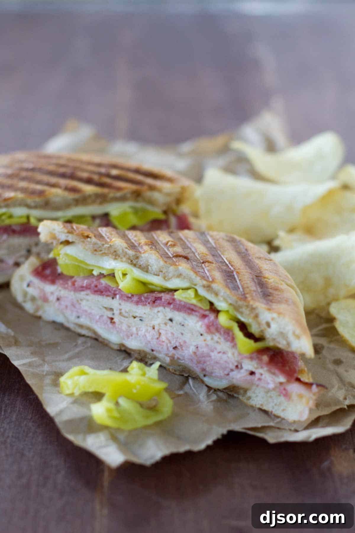 Italian Melt sandwich with potato chips, showcasing a perfectly grilled panini