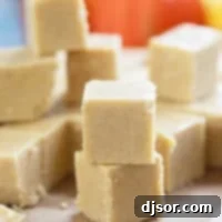 Perfectly cut squares of homemade pumpkin fudge, stacked and ready to enjoy.