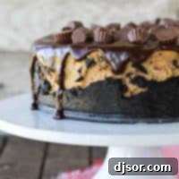 full Reese's Peanut Butter Cheesecake on a cake stand.