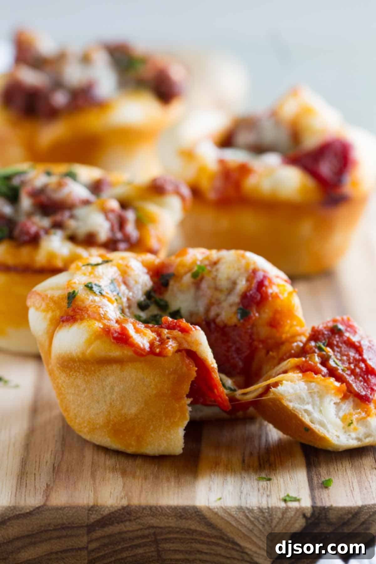 Pizza Poppers 2 Delicious Pizza Cup with a bite taken out, showing melted cheese and savory filling.