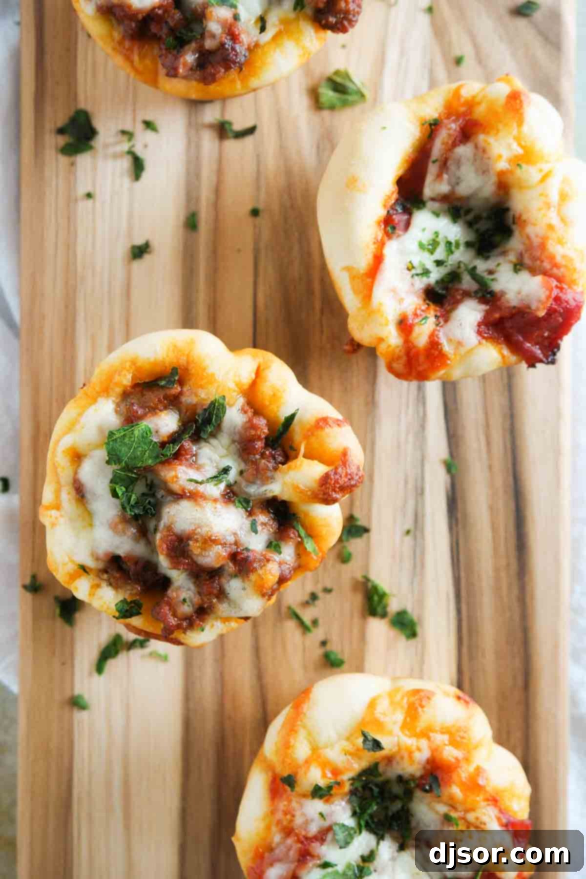 Savory Pizza Muffins 4 An overhead view of golden-brown Pizza Cups, freshly baked in a muffin tin, ready to be served.