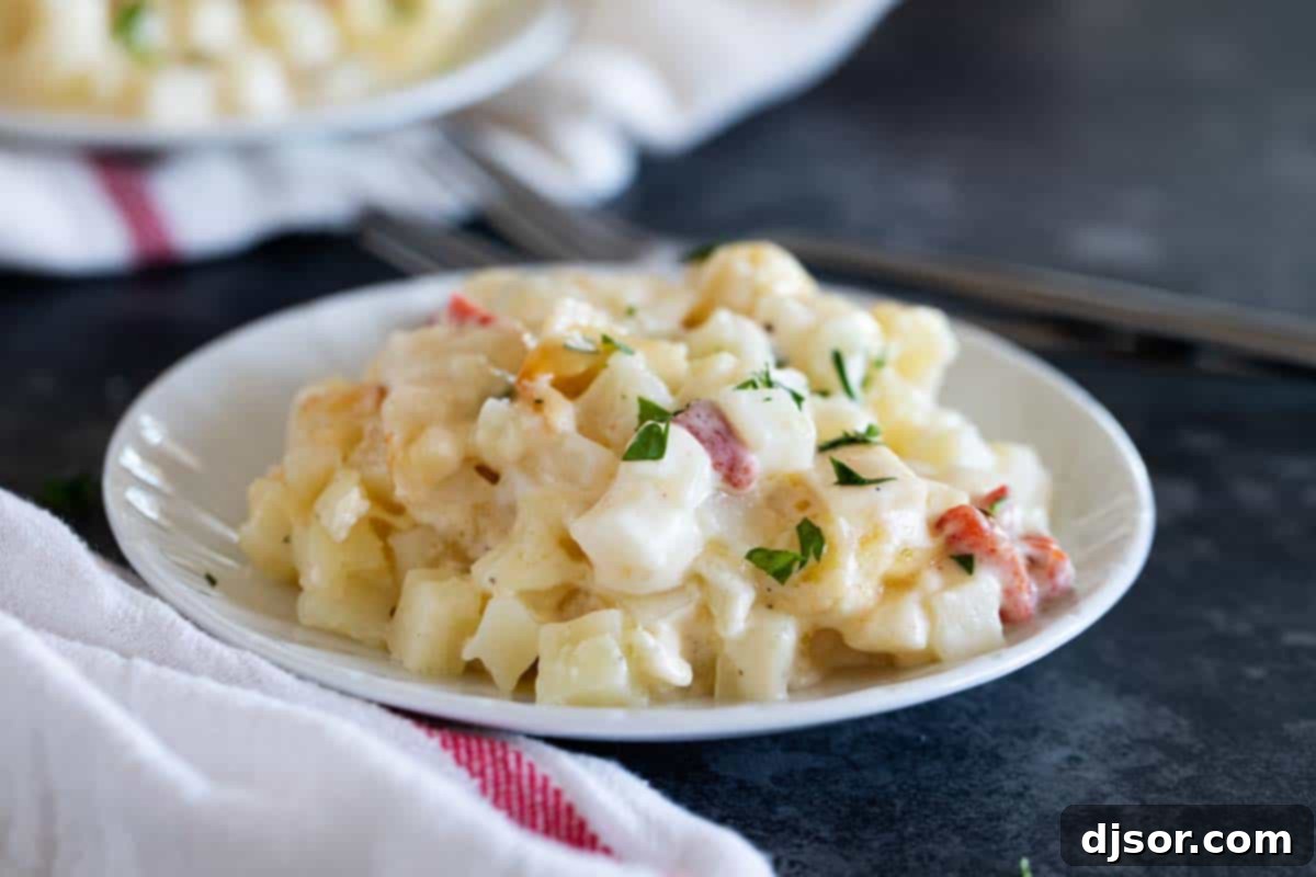 A plate featuring a generous serving of Crockpot Cheesy Potatoes, garnished with fresh parsley.