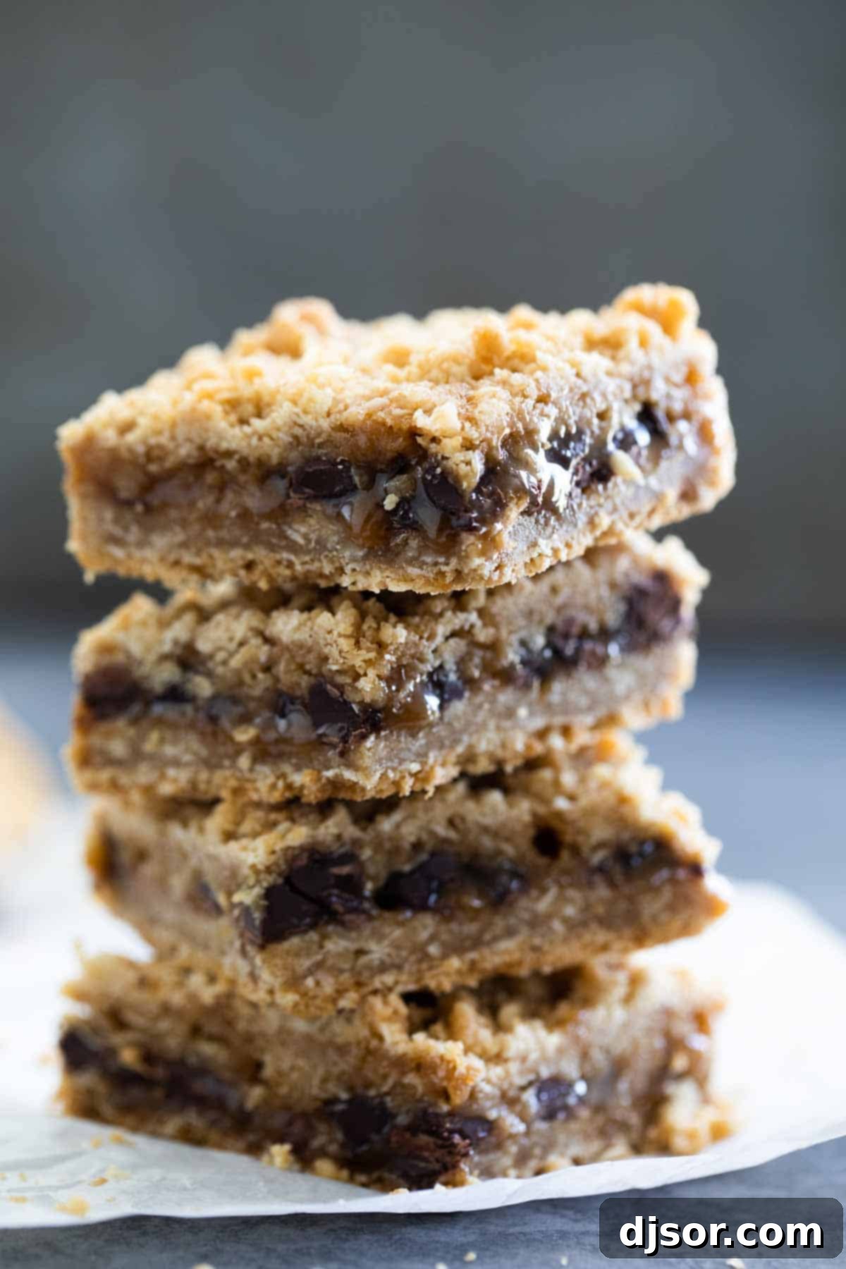 Oatmeal Carmelita Bars stacked neatly on top of each other.