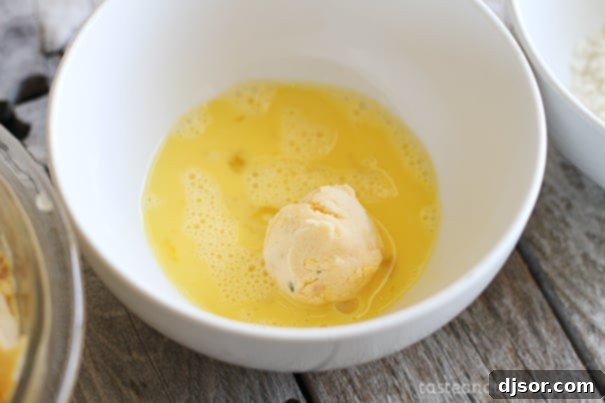 Ultimate Loaded Potato Poppers 5 Dipping potato balls in egg wash