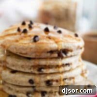 Wholesome Oat & Chocolate Chip Pancakes 3 stack of whole wheat oatmeal pancakes drizzled with syrup