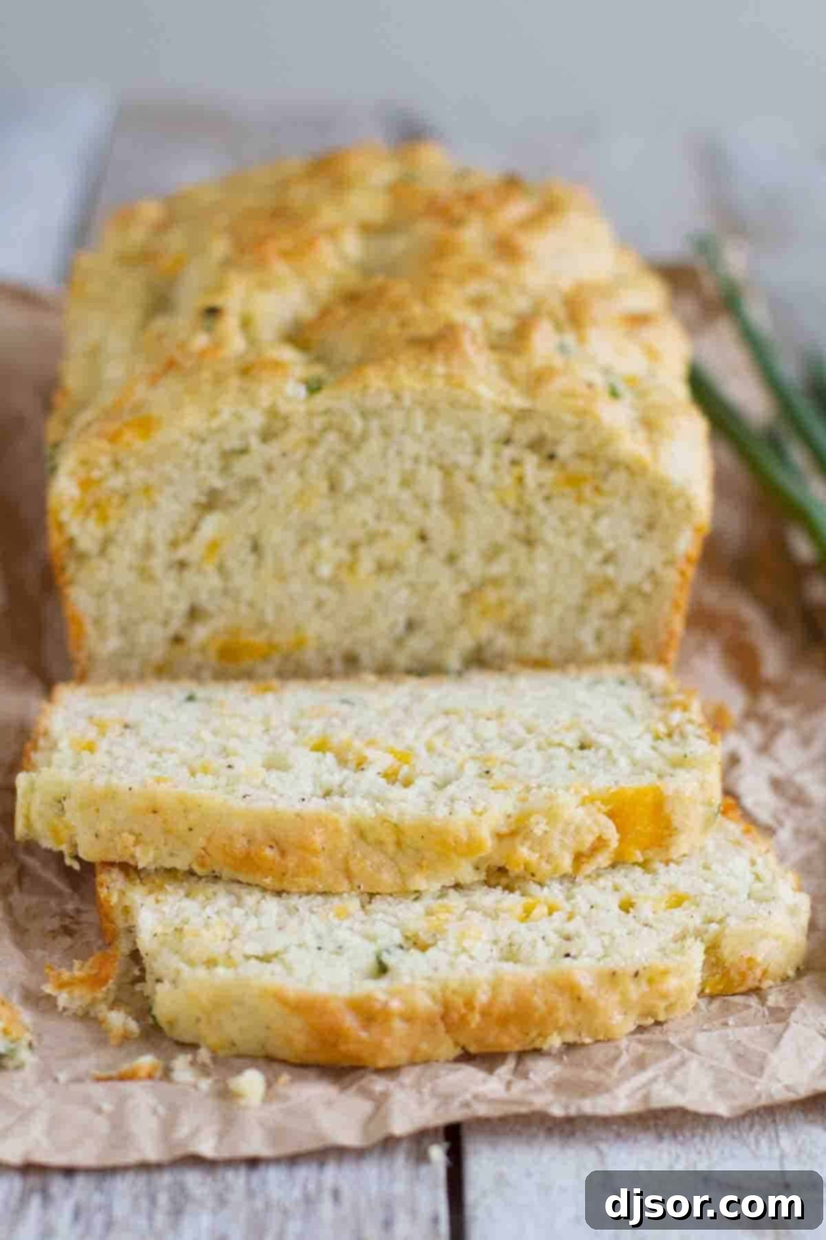 Loaf of Peppery Cheese Bread sliced, revealing a cheesy, peppery interior.