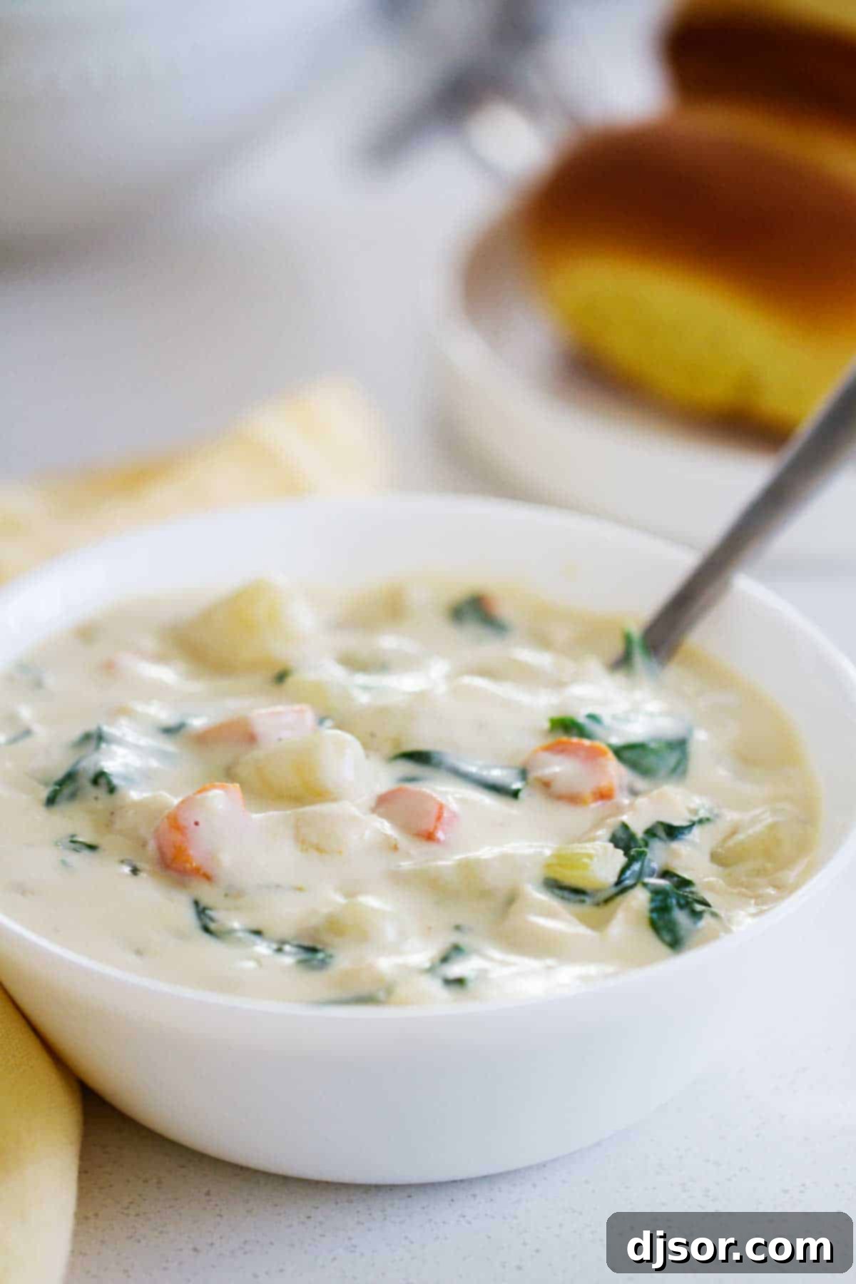 An inviting overhead shot of a bowl of creamy Chicken and Gnocchi Soup, garnished and ready to be enjoyed.