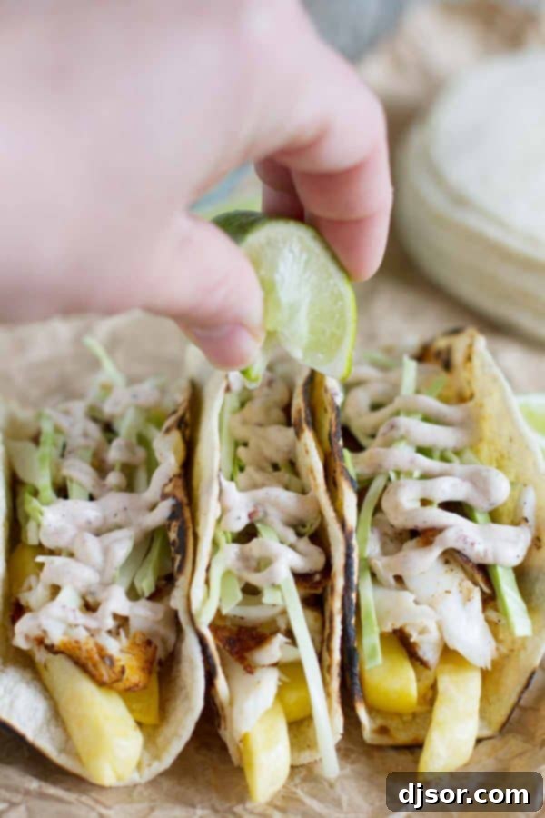 Chip Shop Tacos 5 Hand squeezing fresh lime juice over Fish and Chips Tacos