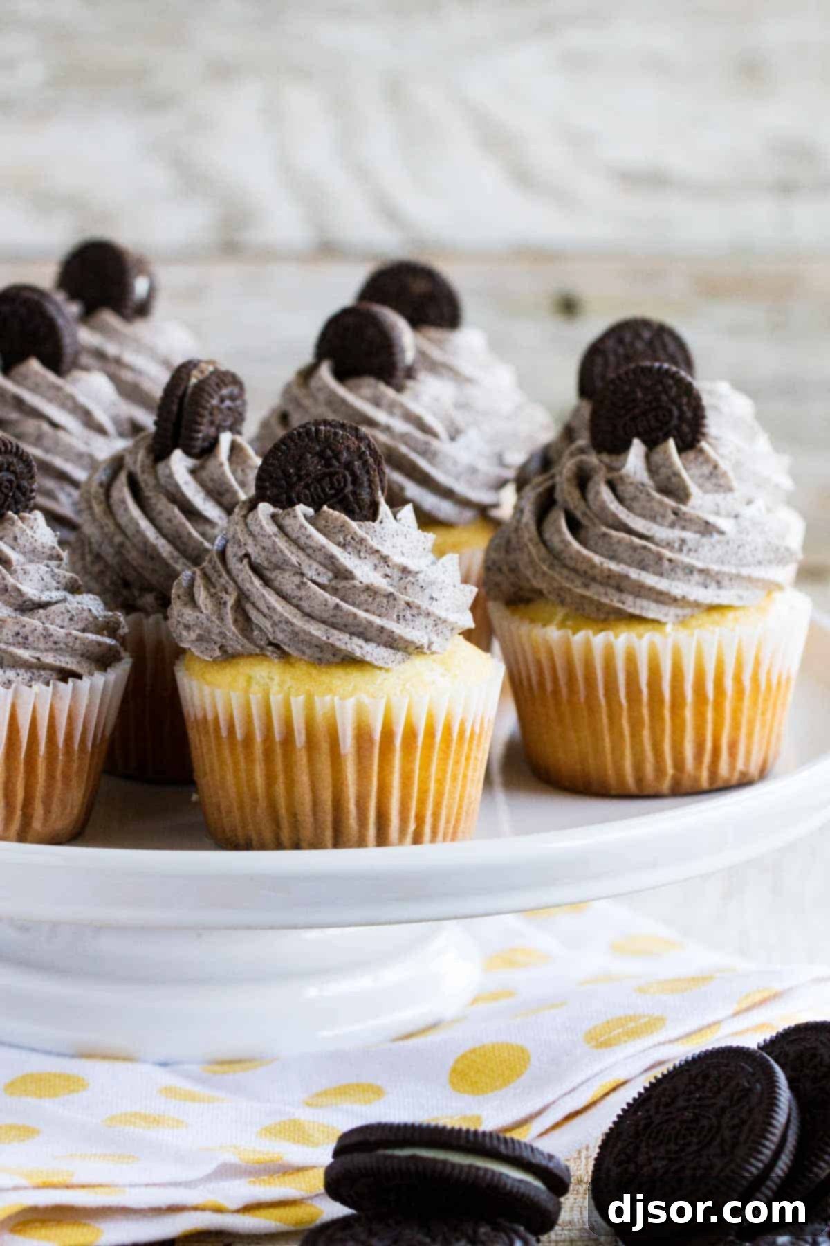 Delicious Cookies and Cream Cupcakes topped with mini Oreos, featuring a marshmallow filling and an Oreo base.