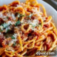 Effortless Spaghetti Meat Sauce 2 Plate filled with spaghetti with meat sauce.