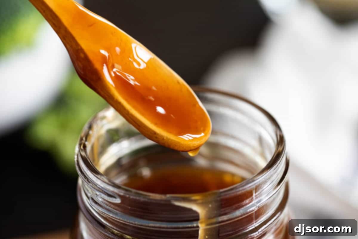 An easy homemade teriyaki sauce recipe made from pantry staples. This sauce is bold and thick and is great as a marinade or as a sauce served with your favorite meats or vegetables. spoonful of homemade teriyaki sauce recipe