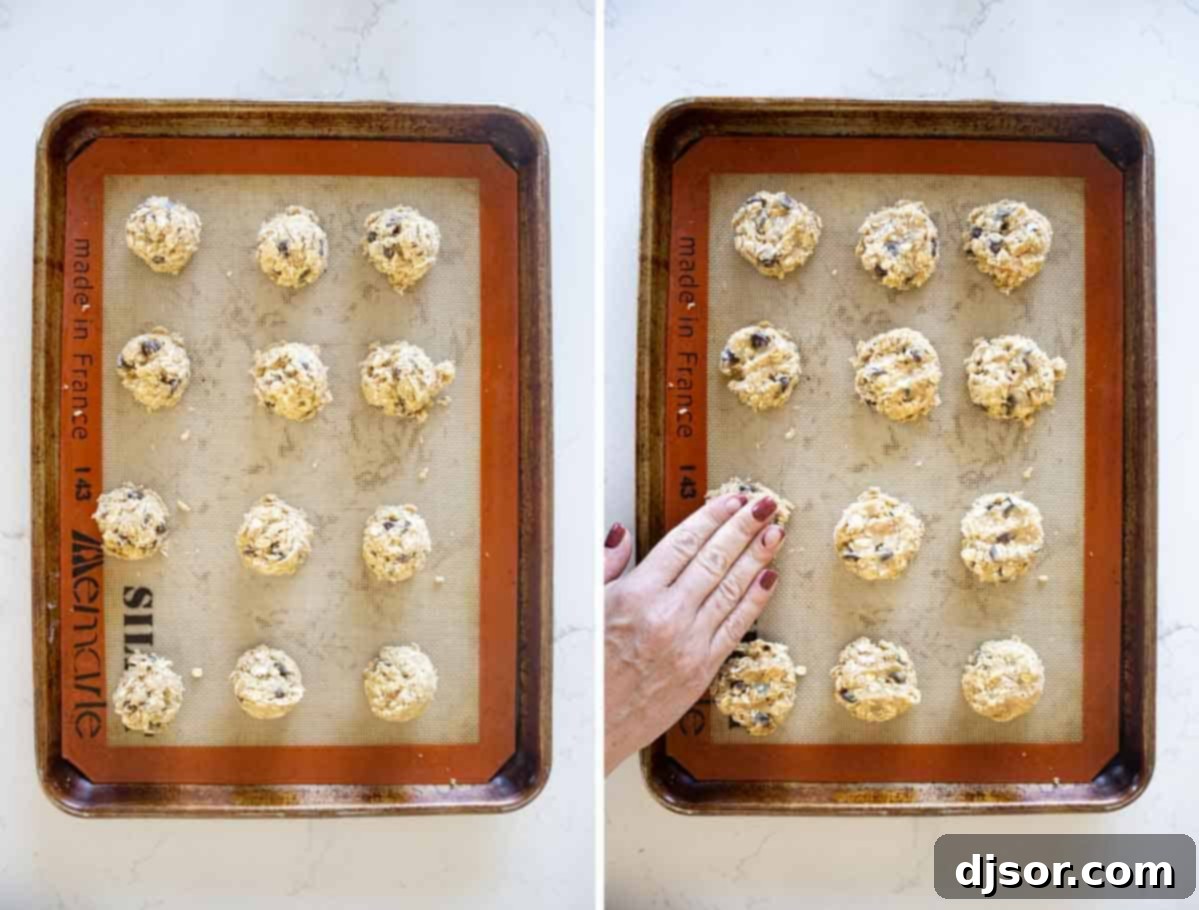 Hands shaping banana oatmeal cookie dough into balls on a baking sheet lined with parchment paper.
