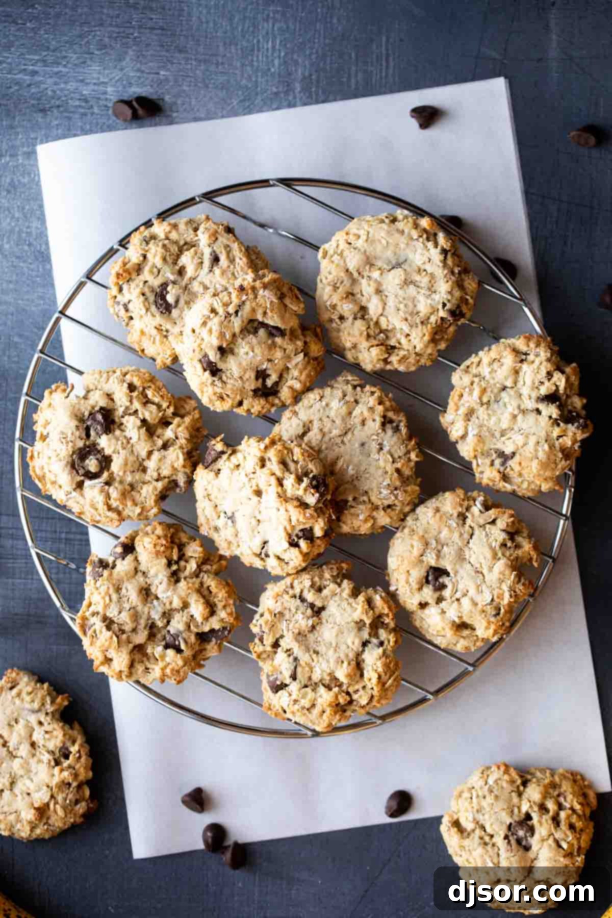 Overhead view of several freshly baked banana oatmeal cookies cooling on a wire rack.