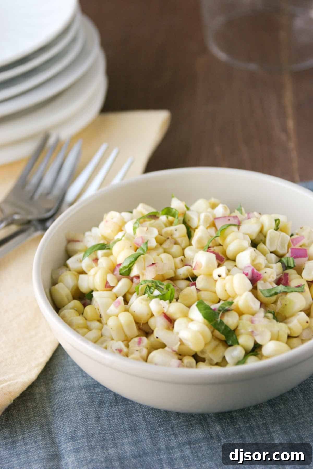 Vibrant Fresh Corn Salad with Red Onion and Basil, ready to serve as a summer side dish