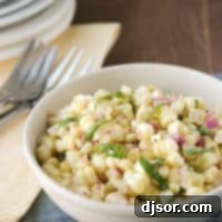 bowl of fresh corn salad topped with fresh basil.