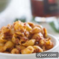 Sun Dried Tomato Pesto Pasta Salad in a white bowl.