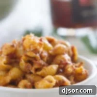 Sun-Kissed Tomato Pesto Pasta Salad 4 Sun Dried Tomato Pesto Pasta Salad in a white bowl.