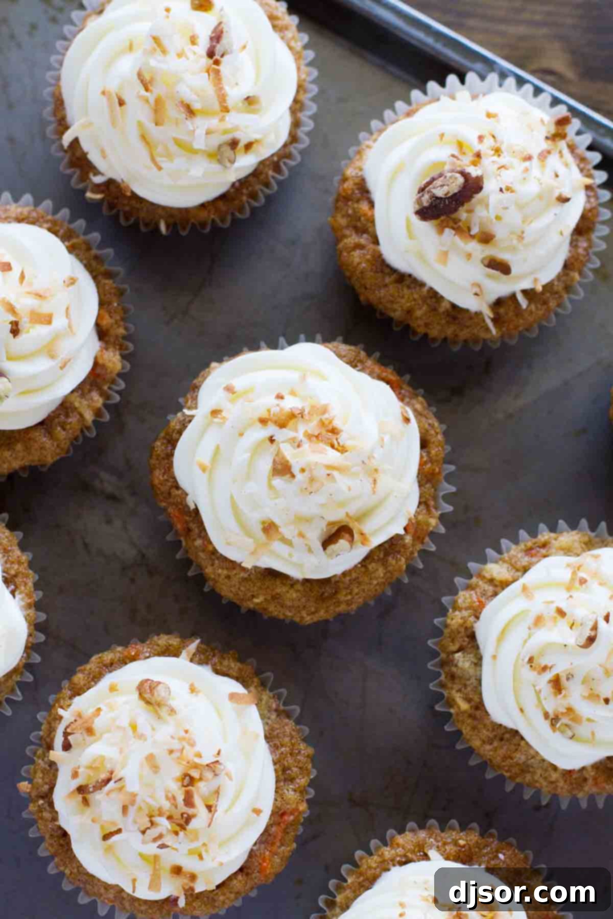 overhead view of carrot cake cupcakes on a baking sheet