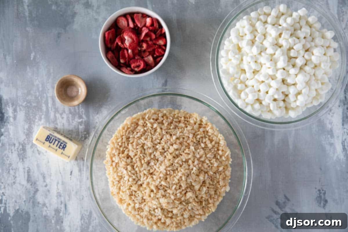 Pink Strawberry Crispy Treats 3 All the essential ingredients for making Strawberry Rice Krispie Treats laid out on a kitchen counter.