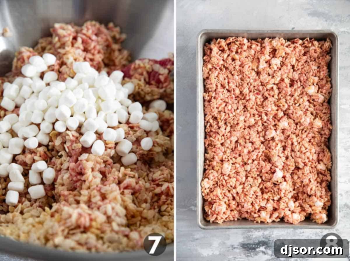 Pink Strawberry Crispy Treats 7 The final step of gently folding in the remaining marshmallows into the strawberry Rice Krispie mixture and pressing it into a baking dish.