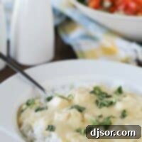 Cheesy Sour Cream Chicken - a comforting and simple meal. Cheesy Sour Cream Chicken served over rice and topped with basil.