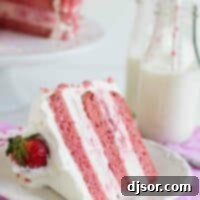 Strawberry Milkshake Ice Cream Cake: A detailed view of a delicious slice. A beautiful slice of Strawberry Milkshake Ice Cream Cake served on a white plate, ready to be enjoyed.