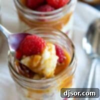 spoonful of rice pudding with caramel and raspberries showing texture.