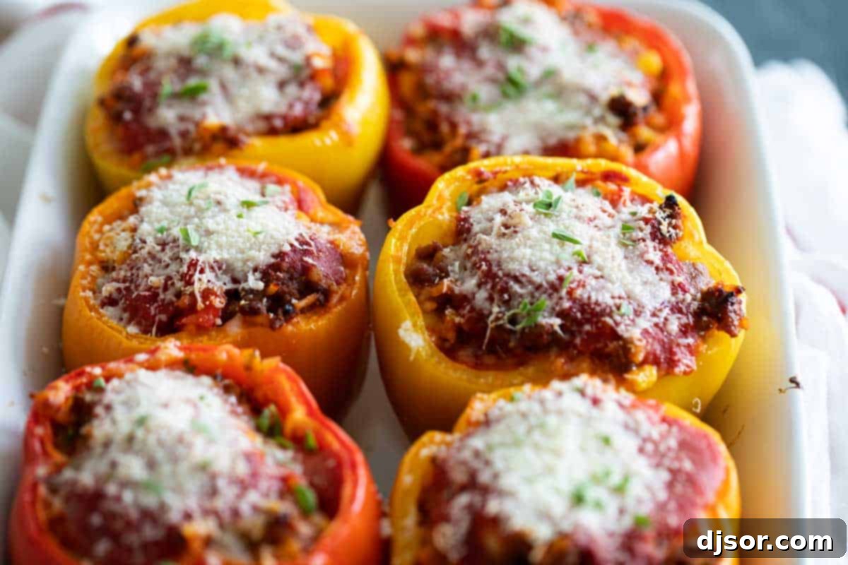 A classic recipe, these Stuffed Bell Peppers are filled with ground beef, Italian sausage, rice, and vegetables. They are hearty and healthy dinner idea. Stuffed Bell Pepper Recipe topped with cheese