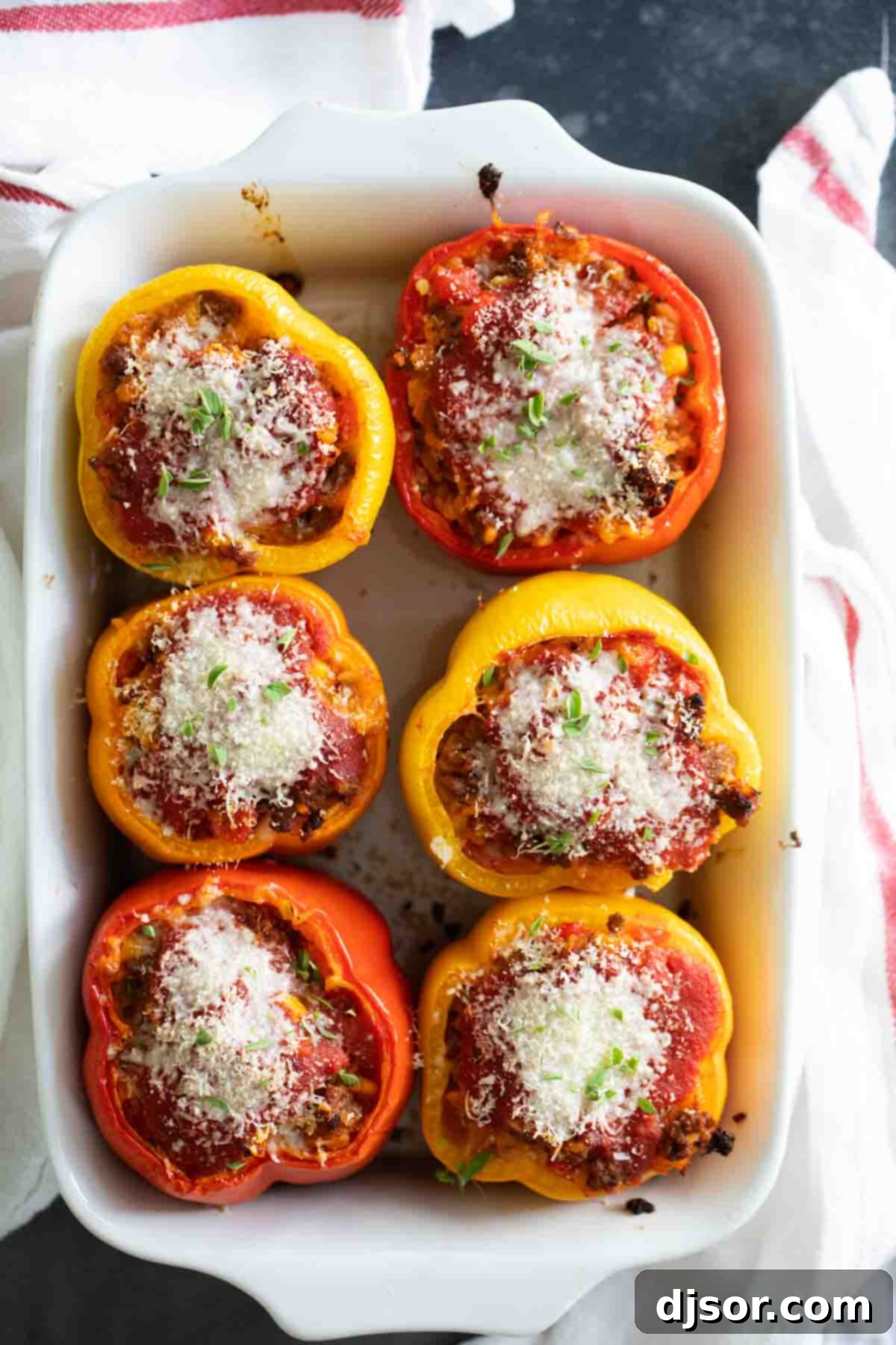 A classic recipe, these Stuffed Bell Peppers are filled with ground beef, Italian sausage, rice, and vegetables. They are hearty and healthy dinner idea. Stuffed Peppers with Ground Beef topped with cheese and herbs