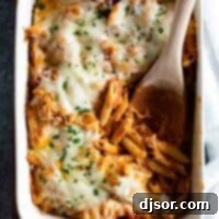 Cheesy Penne Bake 2 overhead view of Penne Pasta Bake recipe with wooden serving spoon