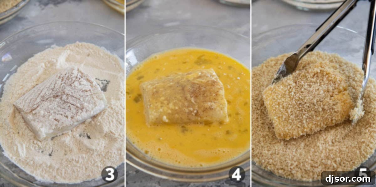 Coating pieces of fish in coating for crispy fish sandwiches.