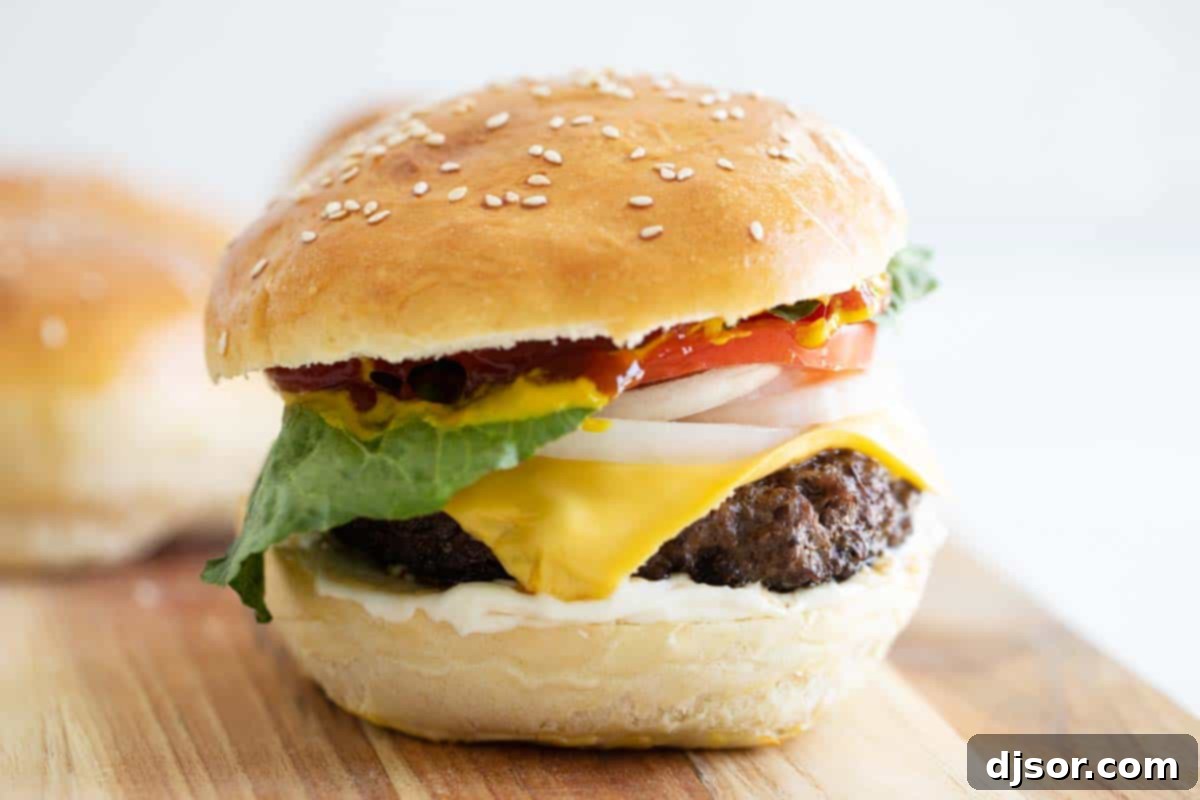 The Ultimate Cheeseburger on a Homemade Hamburger Bun A mouth-watering cheeseburger, perfectly assembled with a juicy patty, melted cheese, and fresh toppings, nestled within a fluffy homemade hamburger bun.