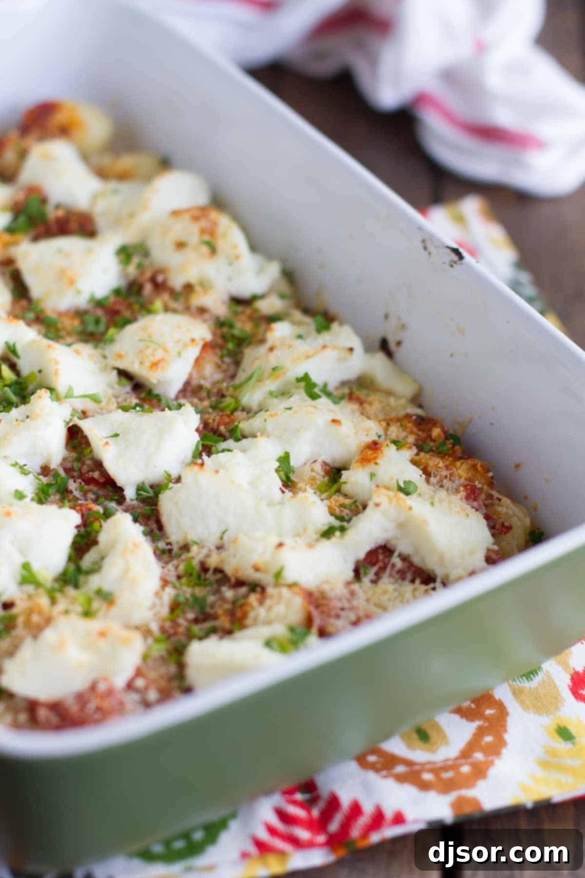 Baked Gnocchi with Ricotta bubbling hot in a baking dish, fresh from the oven, showcasing the golden cheese topping.