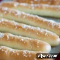 Homemade breadsticks topped with parmesan and garlic