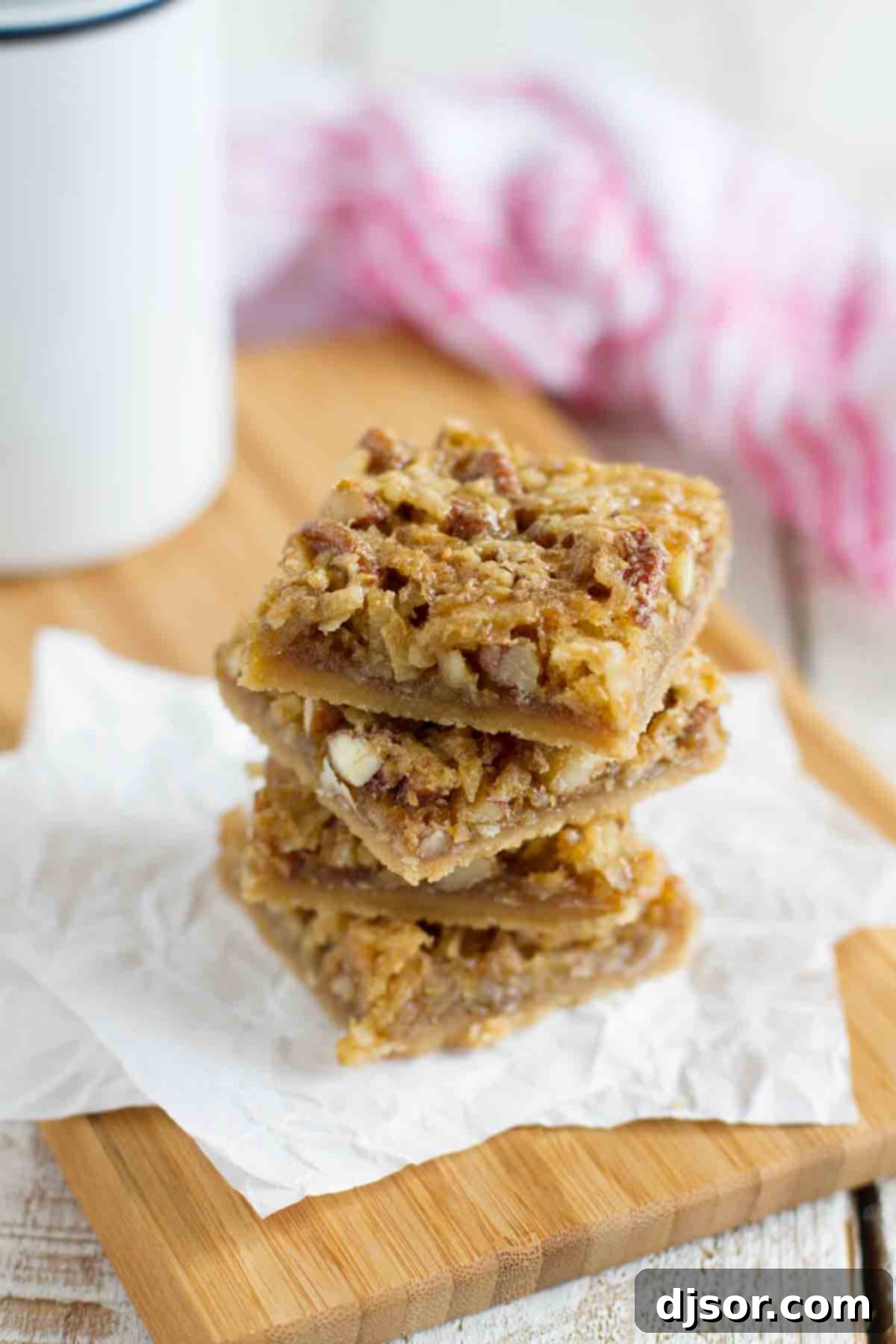 Stacked Coconut Pecan Bars showcasing their delicious layers, golden-brown crust, and rich topping.