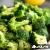 bowl of lemon broccoli with lemons in the back