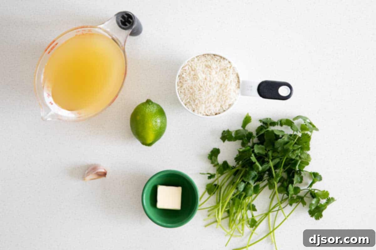 Fresh ingredients laid out on a wooden surface, including uncooked rice, butter, garlic, limes, chicken broth, and cilantro, ready to make cilantro lime rice.
