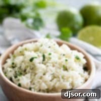 bowl of cilantro lime rice with limes in the background