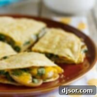 Savory Mushroom Spinach Quesadillas 2 Mushroom Spinach Quesadillas on a plate showing cheese and mushrooms oozing out