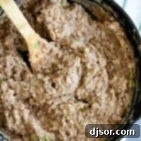 overhead view of refried beans in a cast iron skillet