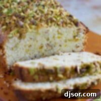 loaf of pistachio lemon pound cake with 2 slices
