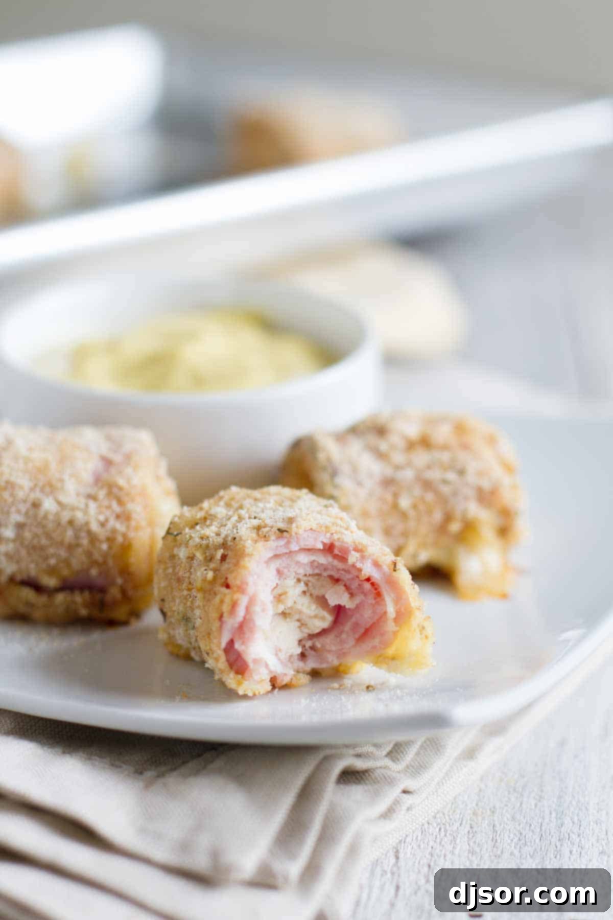 bite taken from a chicken cordon bleu nugget to show inside