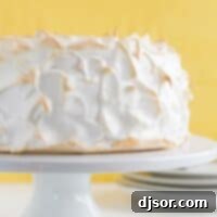 Celestial Lemon Meringue Dream 6 full Lemon Meringue Angel Cake on a cake stand with yellow in the background