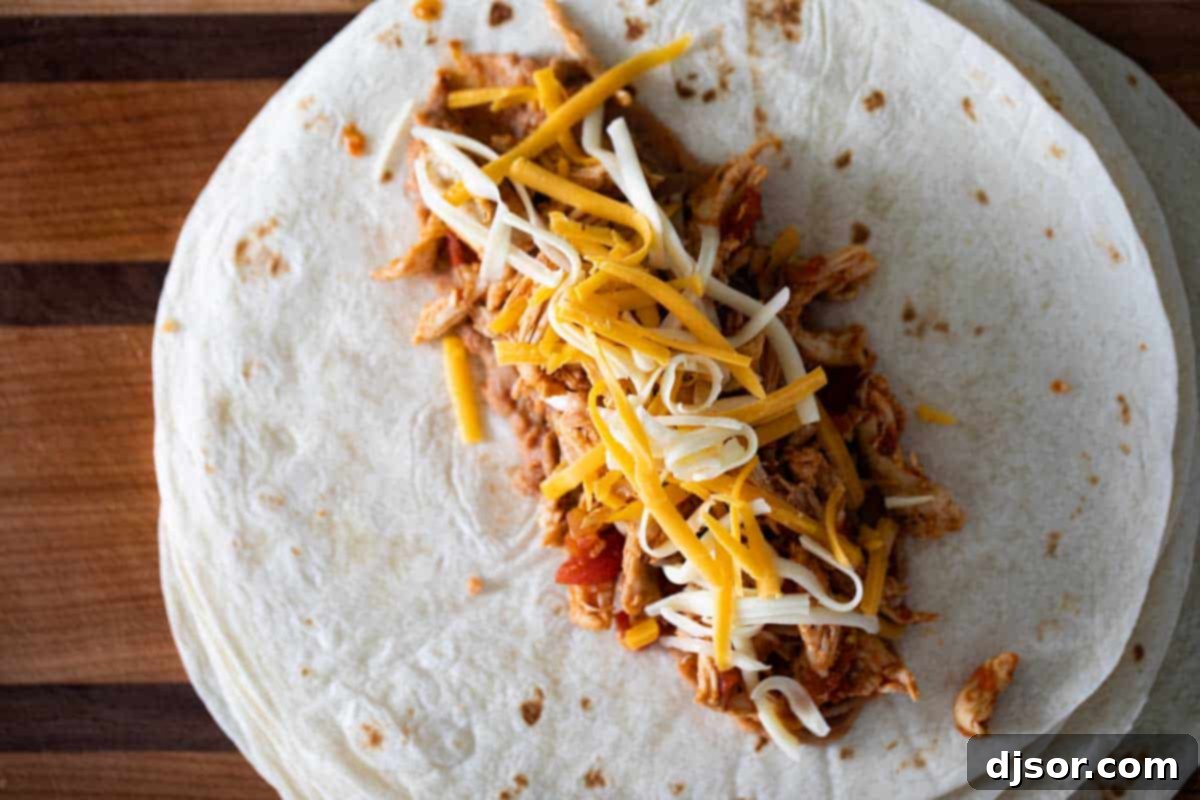 cooking chicken chimichanga filling in a skillet