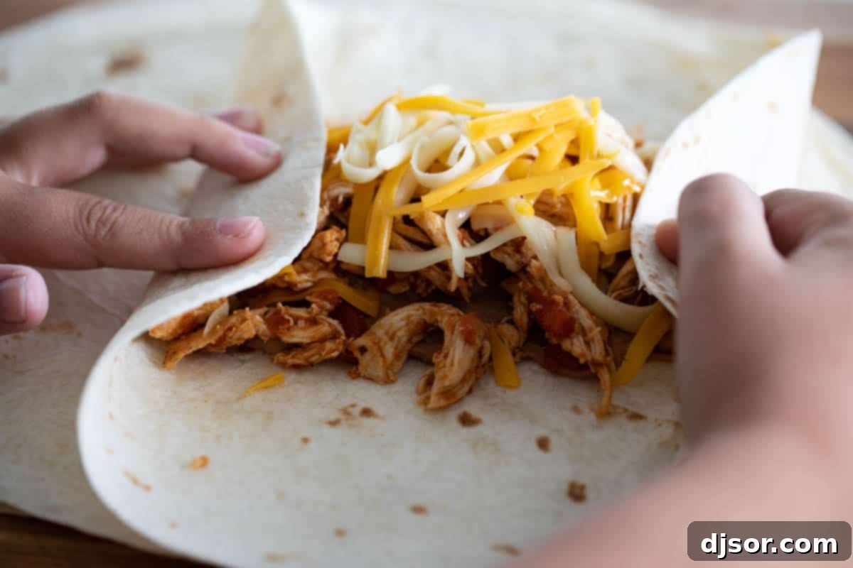 spreading refried beans on a tortilla for chimichangas