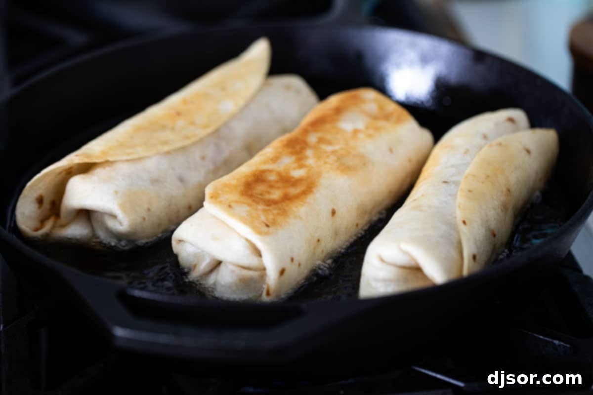 frying chicken chimichangas in hot oil