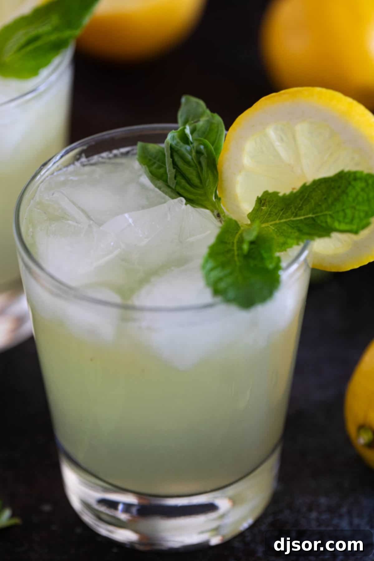 Refreshing Mint Basil Lemonade 6 Mint and Basil Lemonade with ice and fresh lemon slice.