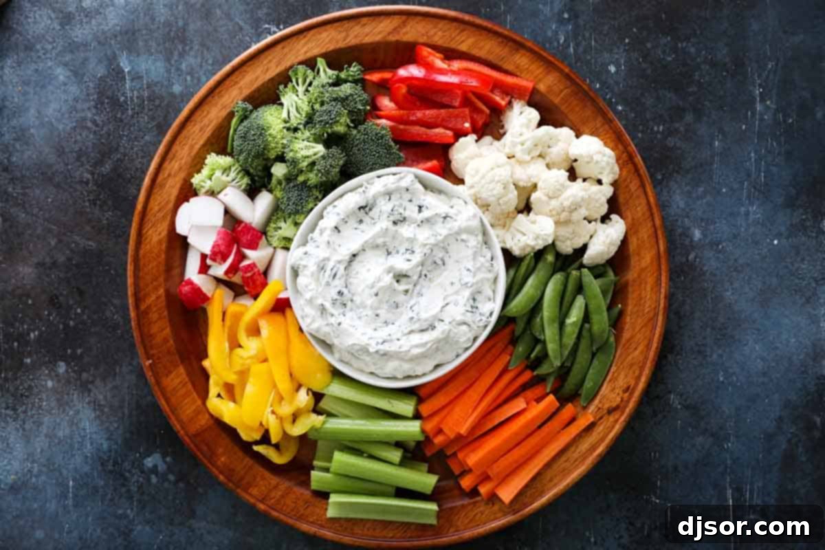 Close up shot of fresh vegetables and spinach dip in a bowl
